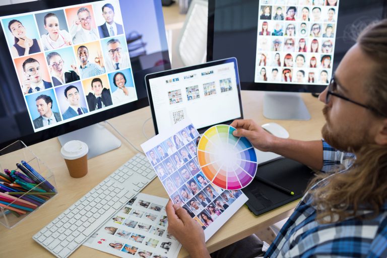 A gentleman looking at colours, laptop and images